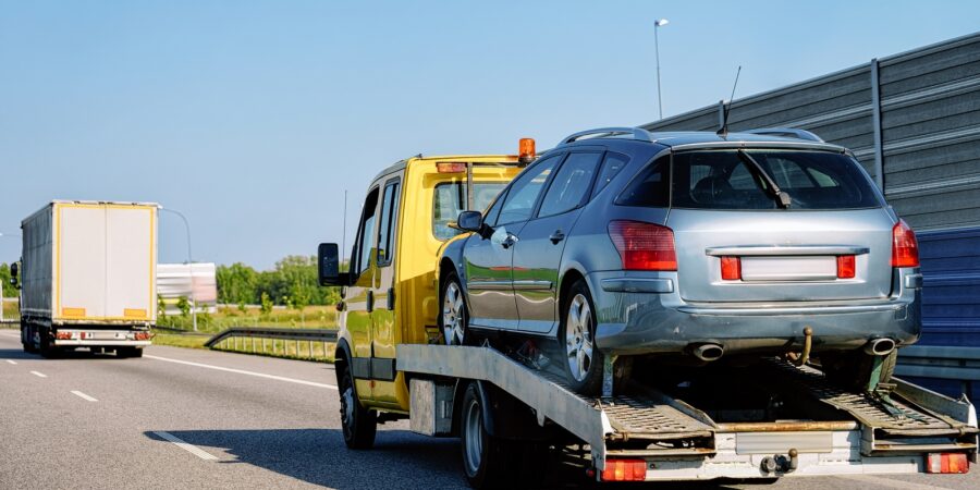 Tow truck transporter carrying car on Road in Slovenia Tow truck transporter carrying car on the Road in Slovenia.